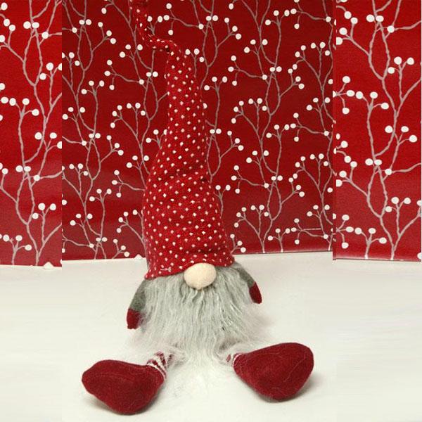 tomte sitting with red and white hat